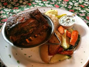 a photo of the slow roasted lamb shoulder served with vegetables