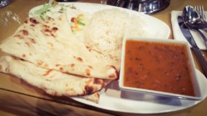 a photo of the combo extras that includes freshly baked naan bread, rice and salad