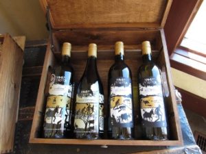 a wooden case containing four bottles of Moon Curser Vineyards wines