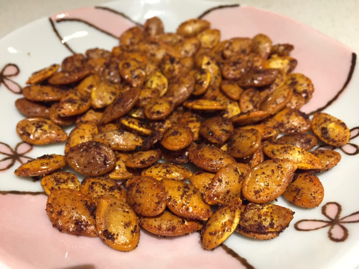 Baked pumpkin seeds on plate photo by Kaila So